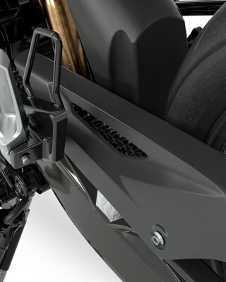We see the swinging arm, chain guard and footrest of the G 310 GS in side view.