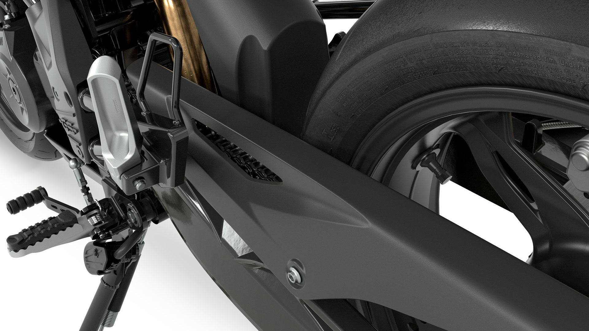 We see the swinging arm, chain guard and footrest of the G 310 GS in side view.