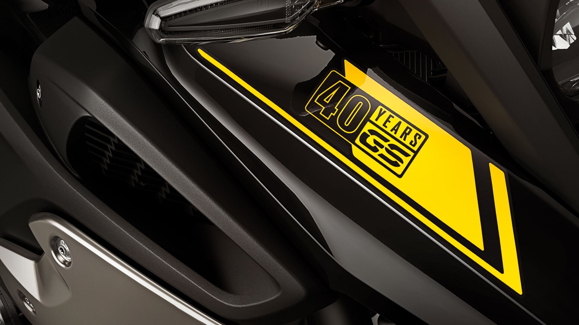 We see a close-up of the 40 Years GS sticker.